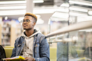 HIGHER EDUCATION PRODUCTS an african american university student studying in the library stock photo