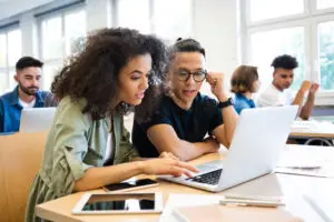 HIGHER EDUCATION PRODUCTS classmates are learning through laptop